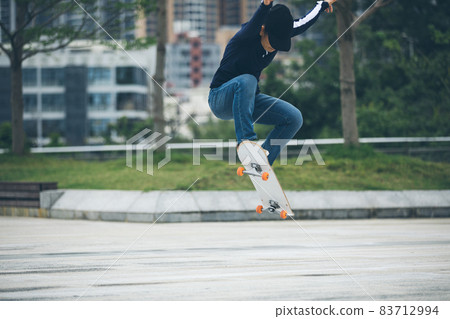 Skateboarder skateboarding outdoors in city Skateboarder skateboarding outdoors in city 83712994