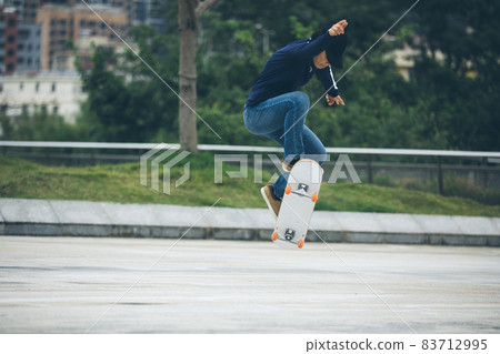 Skateboarder skateboarding outdoors in city Skateboarder skateboarding outdoors in city 83712995