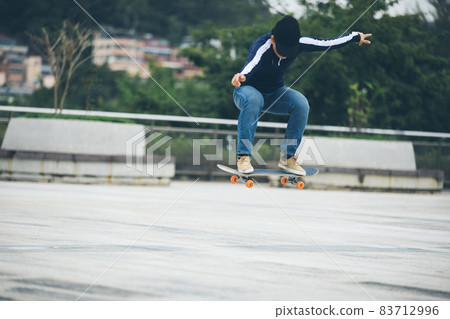 Skateboarder skateboarding outdoors in city Skateboarder skateboarding outdoors in city 83712996