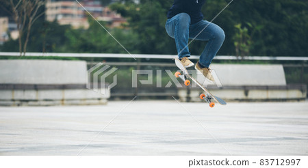 Skateboarder skateboarding outdoors in city Skateboarder skateboarding outdoors in city 83712997