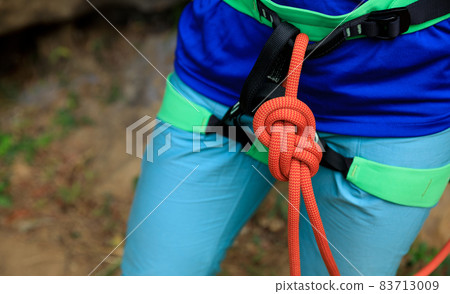 Rock climber making a eight knot 83713009