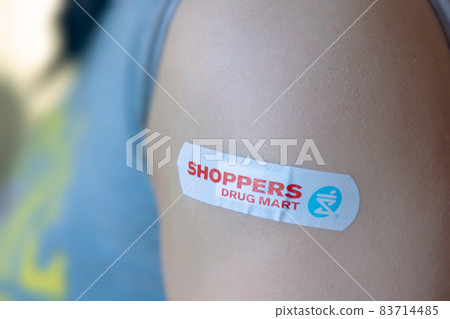 Calgary, Alberta, Canada. Nov 6, 2021. An Adult female with a Vaccine Shoppers Drug Mart Adhesive bandage Calgary, Alberta, Canada. Nov 6, 2021. An Adult female with a Vaccine Shoppers Drug Mart Adhesive bandage 83714485
