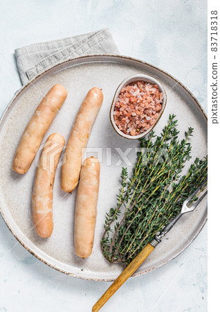 Fried chicken and turkey sausages on a plate. White background. Top view 83718318