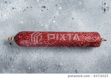 Dry salami sausage. Gray background. Top view Dry salami sausage. Gray background. Top view 83718325