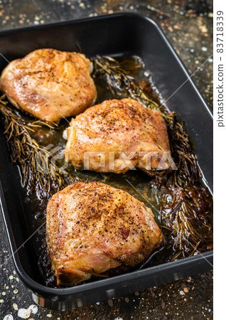 Oven Roasted chicken thighs with spices in baking dish. Brown background. Top View 83718339