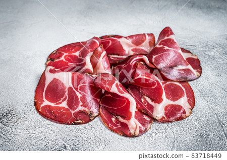 Coppa Cured ham on kitchen table. White background. Top view Coppa Cured ham on kitchen table. White background. Top view 83718449