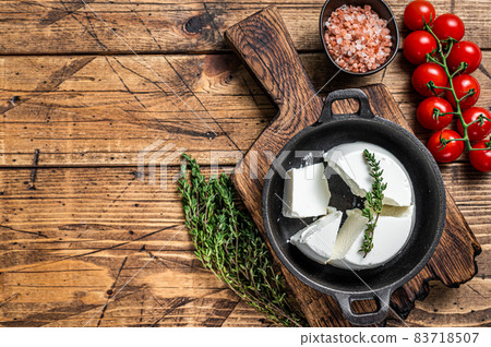 Fresh Ricotta cream Cheese in a pan with basil and tomato. wooden background. Top view. Copy space Fresh Ricotta cream Cheese in a pan with basil and tomato. wooden background. Top view. Copy space 83718507