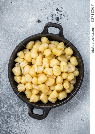 Cooked Gnocchi with Butter and Pepper. Gray background. Top view 83718567