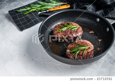 Grilled Fillet Mignon tenderloin meat beef steaks in pan. White background. Top view. Copy space Grilled Fillet Mignon tenderloin meat beef steaks in pan. White background. Top view. Copy space 83718592