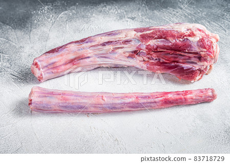 Raw whole Beef veal Oxtail Meat on butcher table. White background. Top view Raw whole Beef veal Oxtail Meat on butcher table. White background. Top view 83718729