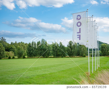 Flags at driving range for practicing golf swing. Nice landscape in sunny day 83719139