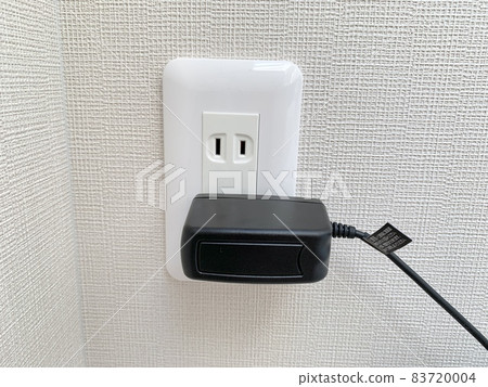 Charger plugged into an outlet photo material 83720004