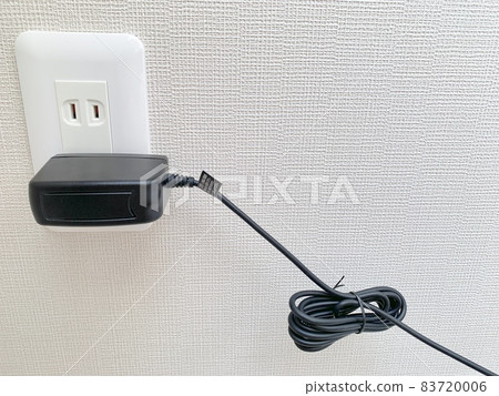 Charger plugged into an outlet photo material 83720006