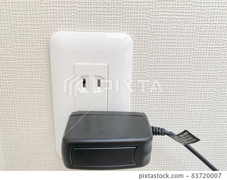 Charger plugged into an outlet photo material 83720007