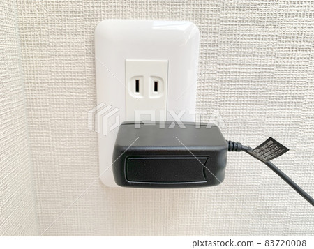 Charger plugged into an outlet photo material 83720008
