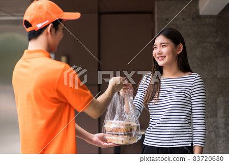 Food delivery to young  Asian woman at condo 83720680