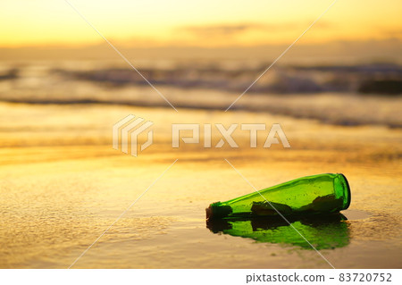 A glass bottle with a letter washed ashore on the beach A glass bottle with a letter washed ashore on the beach 83720752