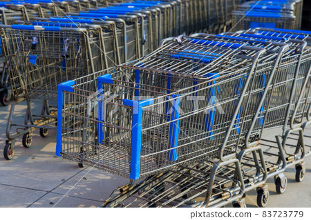 Rows of shopping carts near entrance of supermarket Rows of shopping carts near entrance of supermarket 83723779