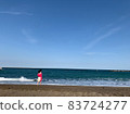Woman standing in the sea 83724277