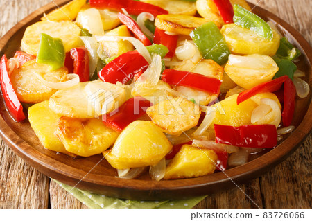 Spanish Patatas a lo Pobre Poor Man's Potatoes close up in the plate. Horizontal 83726066