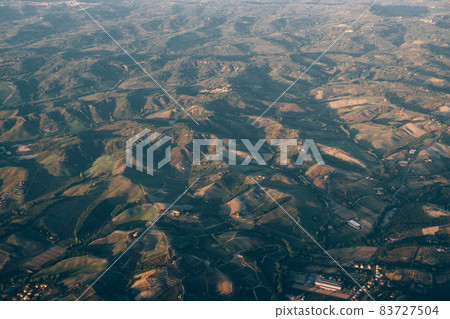 View from the plane window of the mountains of Tuscany View from the plane window of the mountains of Tuscany 83727504