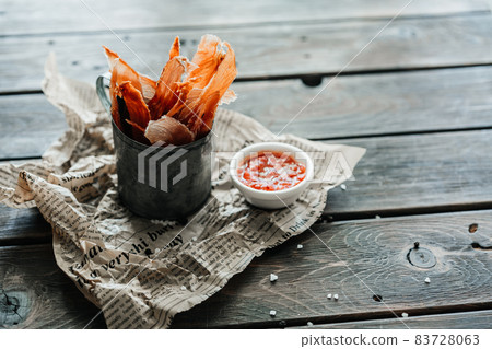 Dried chicken, dried poultry, cut into strips in a metal bucket on a wooden background. Serving a meal in a restaurant Dried chicken, dried poultry, cut into strips in a metal bucket on a wooden background. Serving a meal in a restaurant 83728063