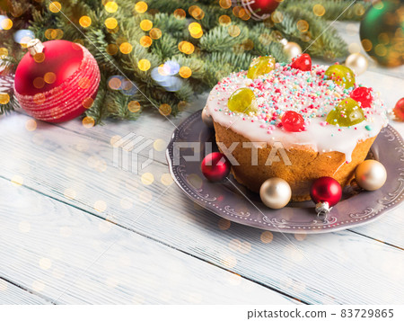 Italian christmas cake with sweet decor and xmas ornament, lights Italian christmas cake with sweet decor and xmas ornament, lights 83729865