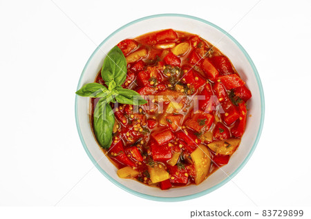 Vegetable dish of stewed sweet peppers and tomatoes, lecho, vegetarian menu. Studio Photo. 83729899