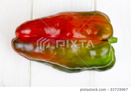 Multicolored sweet peppers and tomatoes on wooden table. Studio Photo. 83729967