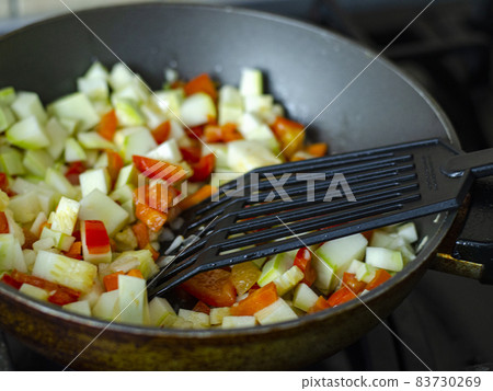 Cubes of fresh vegetables are fried in pan. Studio Photo Cubes of fresh vegetables are fried in pan. Studio Photo 83730269