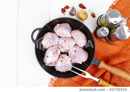 Raw pieces of chicken leg in skillet for cooking. Studio Photo. Raw pieces of chicken leg in skillet for cooking. Studio Photo. 83730550