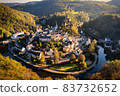Aerial view of Esch-sur-Sure, medieval town in Luxembourg, dominated by castle, canton Wiltz in Diekirch. Forests of Upper-Sure Nature Park, meander of winding river Sauer, near Upper Sauer Lake. 83732652