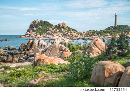 Scenic view of the lighthouse on the beautiful shore with large stones. The beauty of nature. Amazing places in the world. bay with crystal water Scenic view of the lighthouse on the beautiful shore with large stones. The beauty of nature. Amazing places in the world. bay with crystal water 83733264