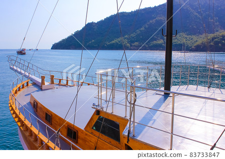 Yacht on the shore of the cozy bay of Adrasan, near Antalya and Kemer, Turkey Yacht on the shore of the cozy bay of Adrasan, near Antalya and Kemer, Turkey 83733847