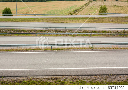 Empty asphalt roads without cars at autumn evening in Finland. Empty asphalt roads without cars at autumn evening in Finland. 83734031