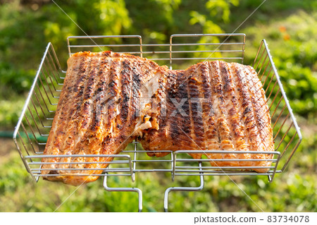 Cooking salmon steak on barbecue grill outdoors. Selective focus Cooking salmon steak on barbecue grill outdoors. Selective focus 83734078