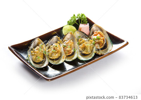 Garlic mussels in a plate on white background. Garlic mussels in a plate on white background. 83734613