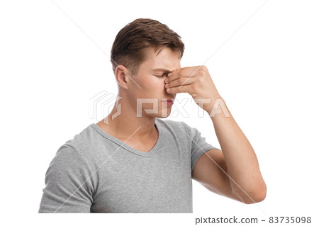Despaired sad millennial european male presses hand to nose, suffers from migraine or runny nose Despaired sad millennial european male presses hand to nose, suffers from migraine or runny nose 83735098