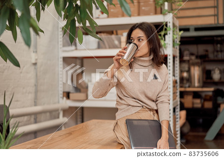Freelancer leaning on table and drinking coffee 83735606