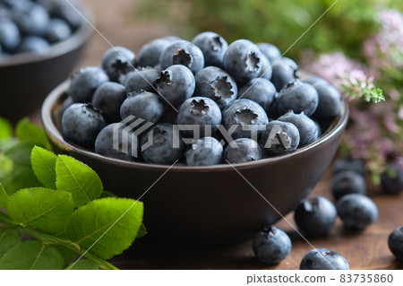 Bowl of fresh ripe blueberries on kitchen table. Bowl of fresh ripe blueberries on kitchen table. 83735860
