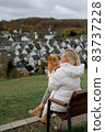 young woman with a pretty pom spitz in beautiful old german town Freudenberg 83737228