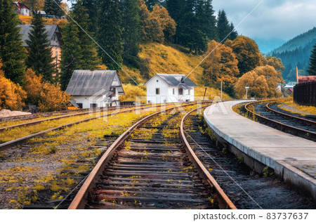Railway station and white house in mountain village at sunset Railway station and white house in mountain village at sunset 83737637