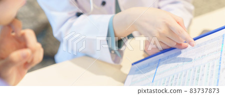 Young woman receiving medical attention from a doctor 83737873