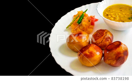 Dal, Bati ,A traditional Indian food , typically prepared in Rajasthan Dal, Bati ,A traditional Indian food , typically prepared in Rajasthan 83738198