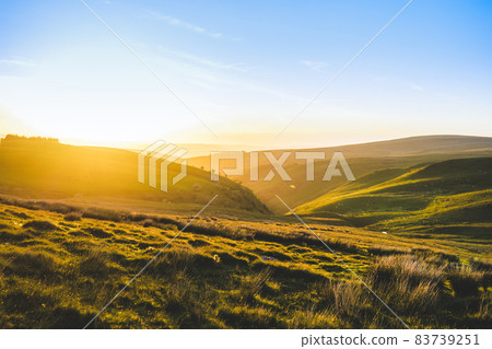 Beautiful landscape view of green fields and meadows at sunset in Snowdonia, Wales. The beauty of nature. Beautiful landscape view of green fields and meadows at sunset in Snowdonia, Wales. The beauty of nature. 83739251