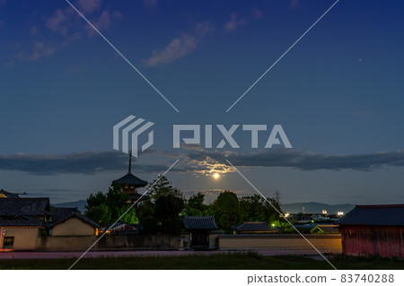 Ikaruga Town, Nara Prefecture, a harvest moon rising from the other side of the three-storied pagoda of Hokiji Temple, a World Heritage Site 83740288