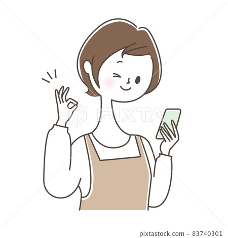 A woman holding a smartphone and giving an OK sign 83740301