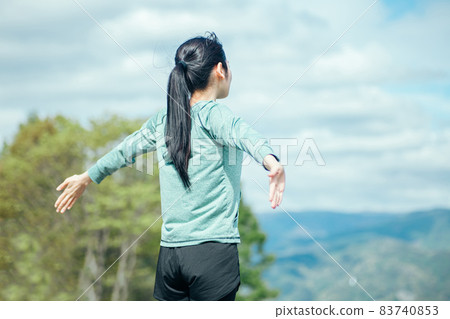 Woman taking a deep breath (back view) Woman taking a deep breath (back view) 83740853