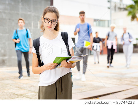 Girl in with backpack and notebooks going to college 83744228