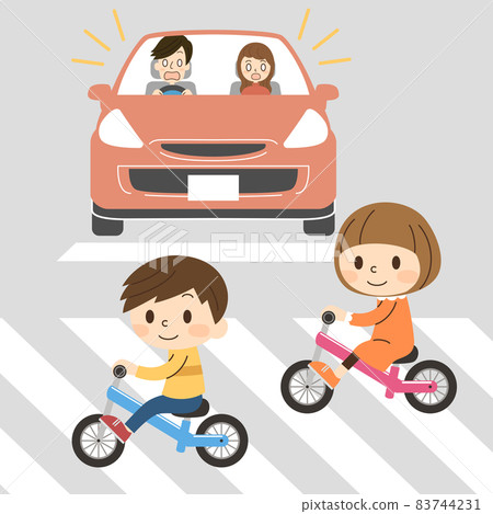 Two kids biking across a pedestrian crossing-dangerous Two kids biking across a pedestrian crossing-dangerous 83744231